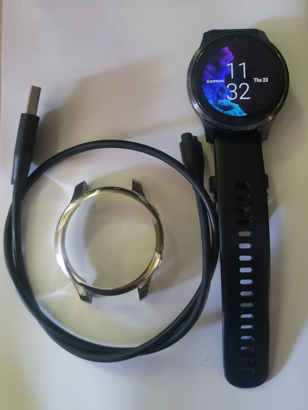 Garmin Black Smartwatch with Silver Bezel and USB Charging Cable